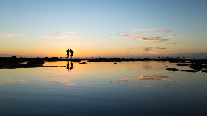 Two people at sunset by Sebastien Gabriel